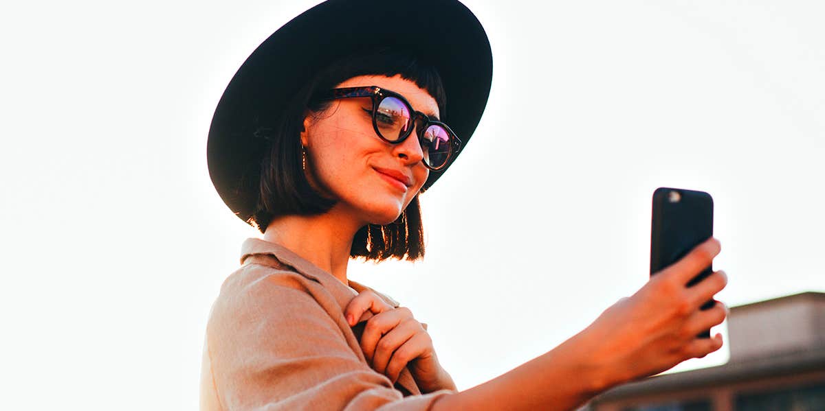 girl taking selfie with phone