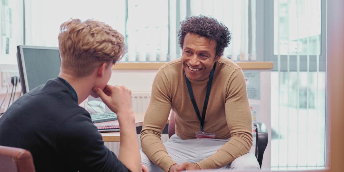 Teacher talking to student in an office