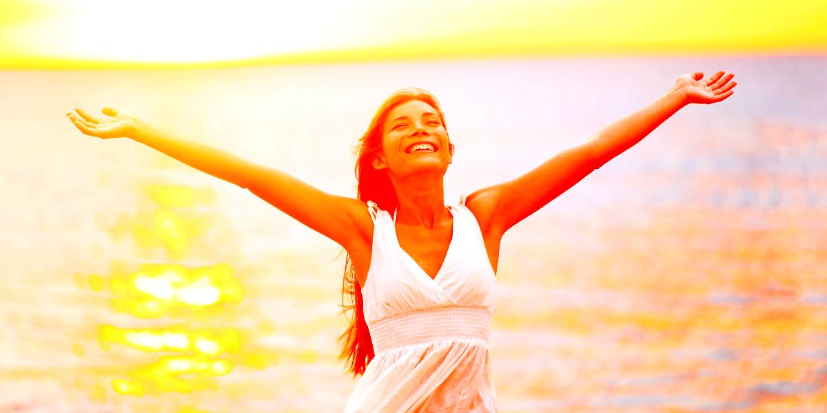 Woman looks free and relaxed near the water