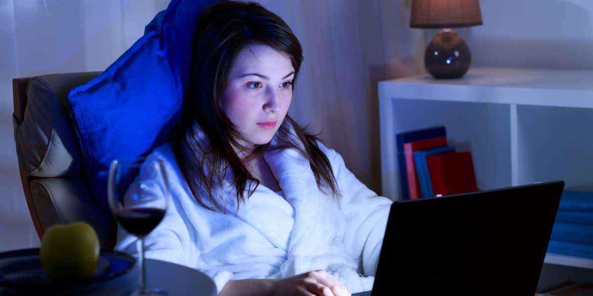 woman on computer in dark