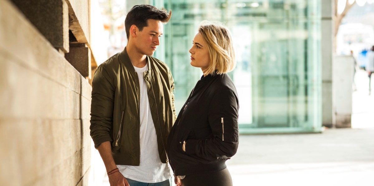 solemn man and woman outside in jackets