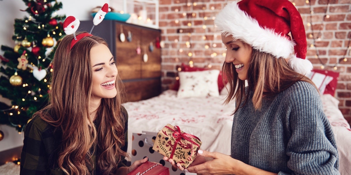 two women exchanging Christmas gifts