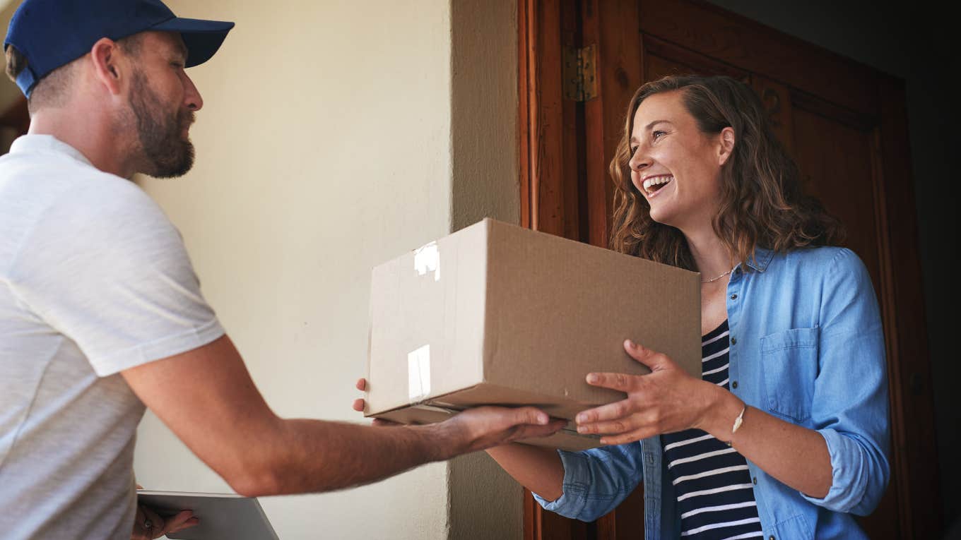 Homeowners Association Member Fines Neighbor For Having Too Many Packages On Their Front Porch woman receiving package from male courier
