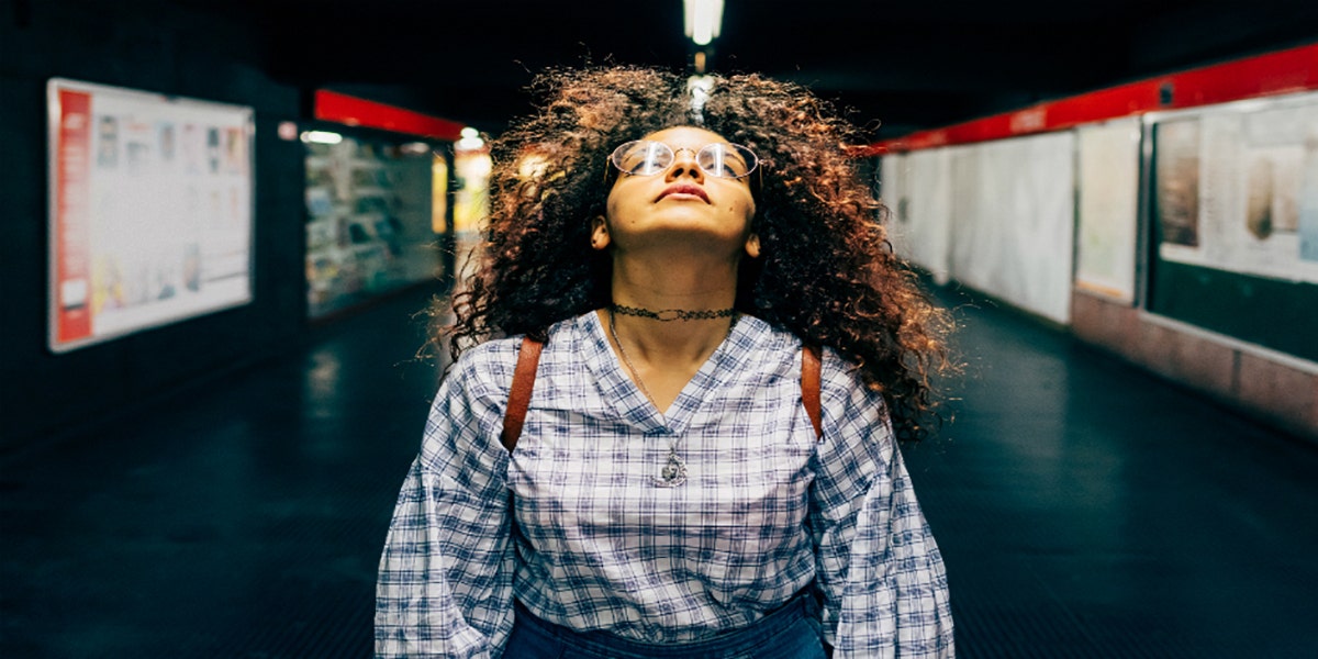 woman looking up in subway station