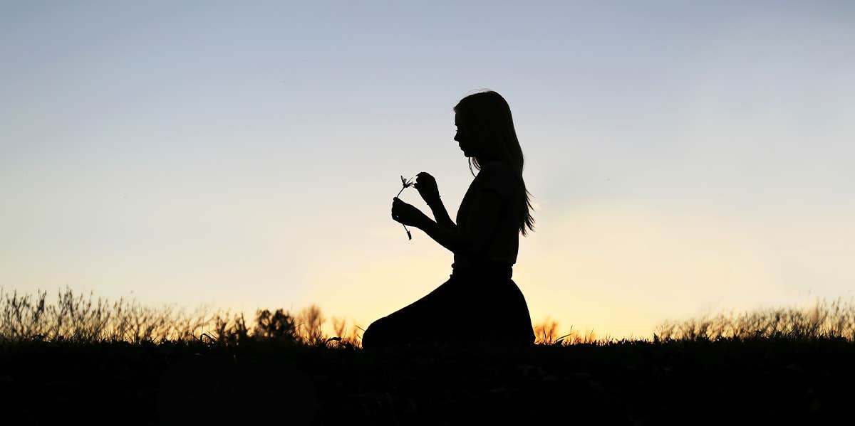 woman picking flower petals