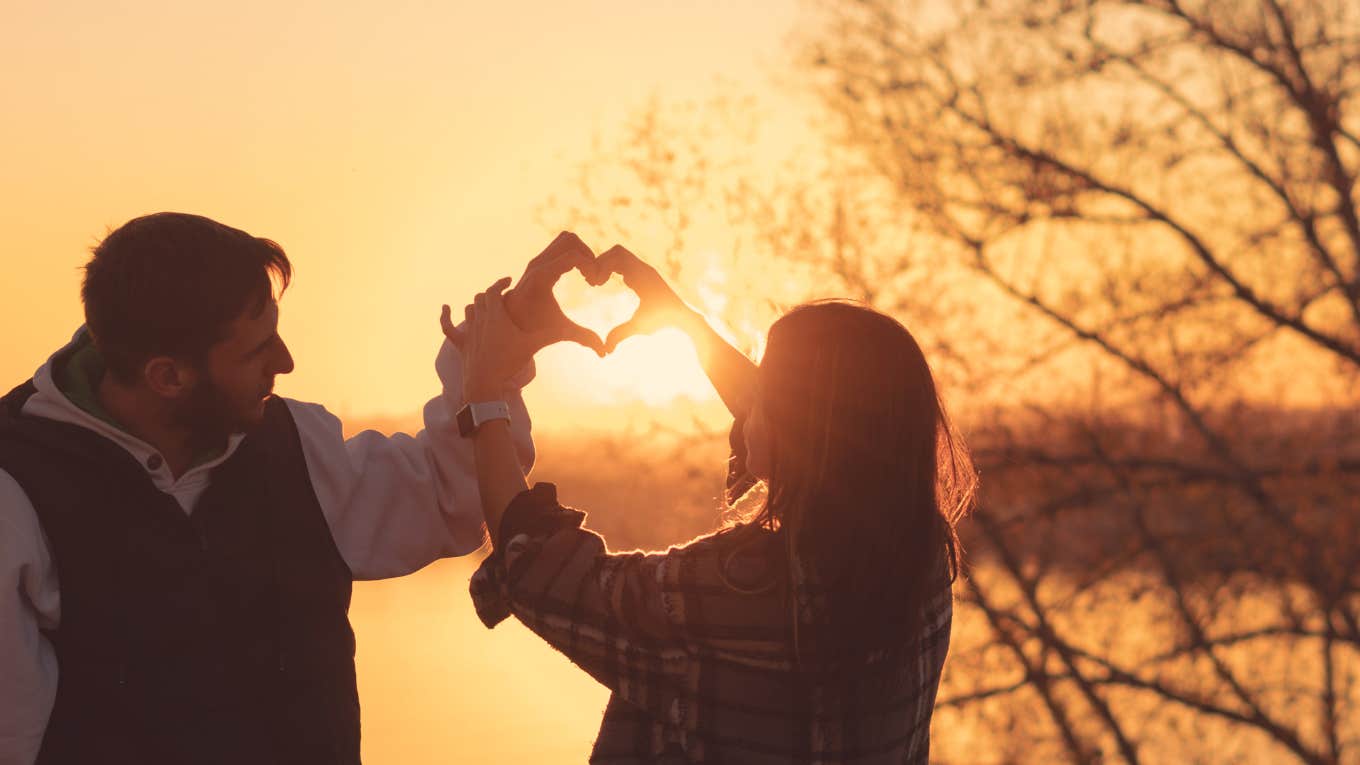 couple making heart with hands