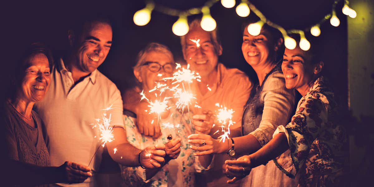 extended family members hold sparklers 