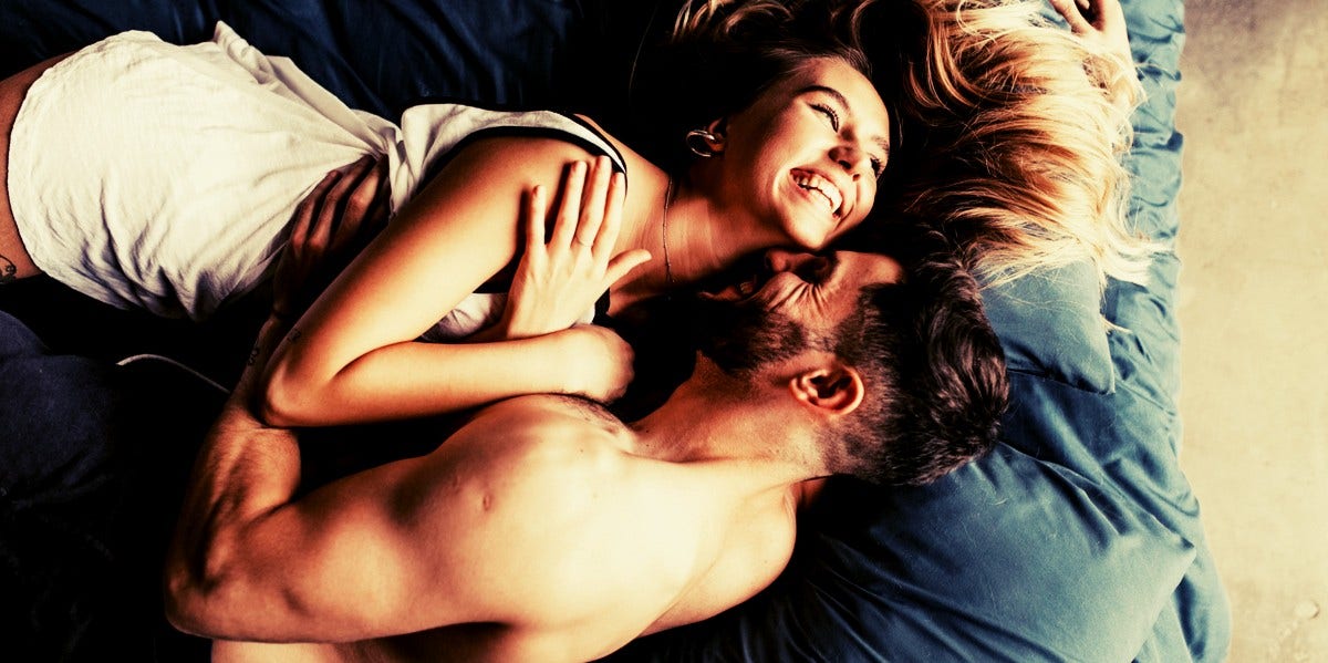 smiling couple in bed