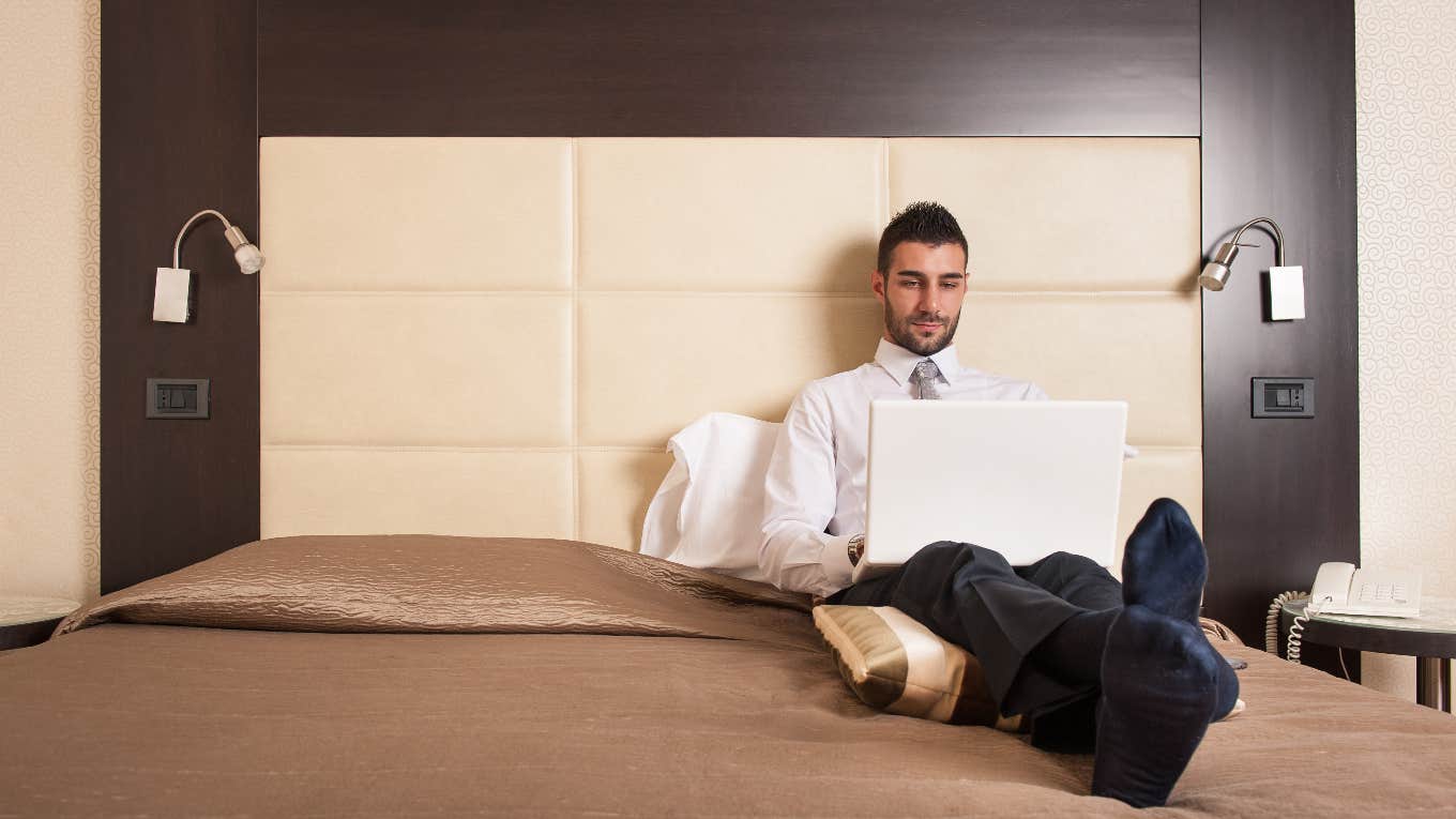 Hotel Chain Forces Two Male Employees To Share A Bed On A Work Trip employee on hotel bed for work trip