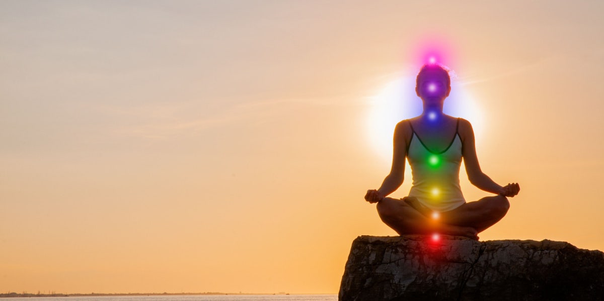 How To Balance Your Chakras In 9 Steps woman balancing her chakras