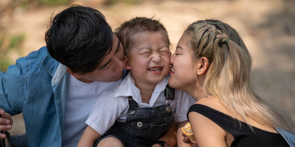 family kissing baby