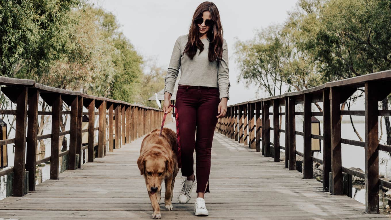 20 Little Tricks The Smartest Women Use To Feel Instantly Happier Woman walking her dog