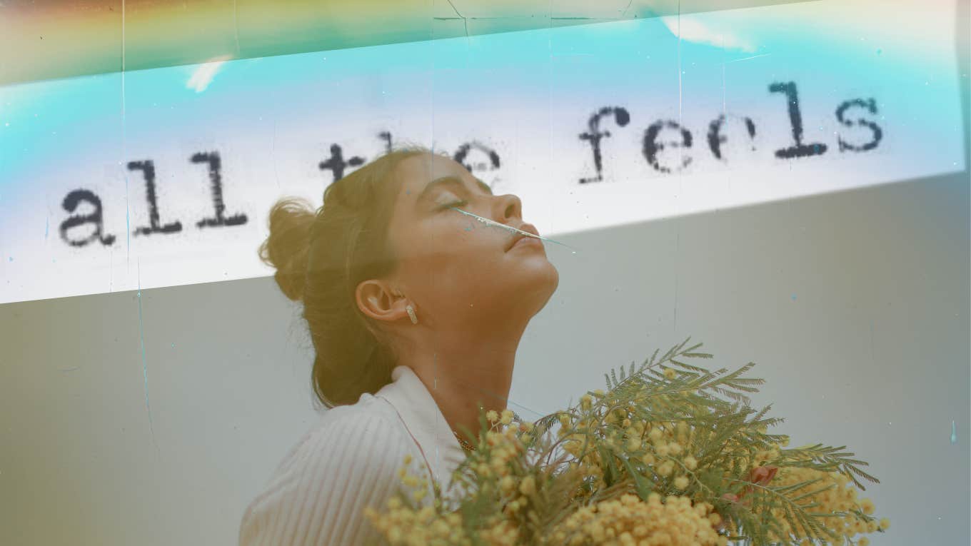 Woman holding flowers, looking up