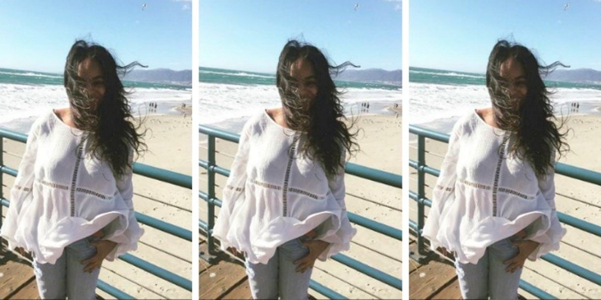 woman on beach with hair blowing in the wind