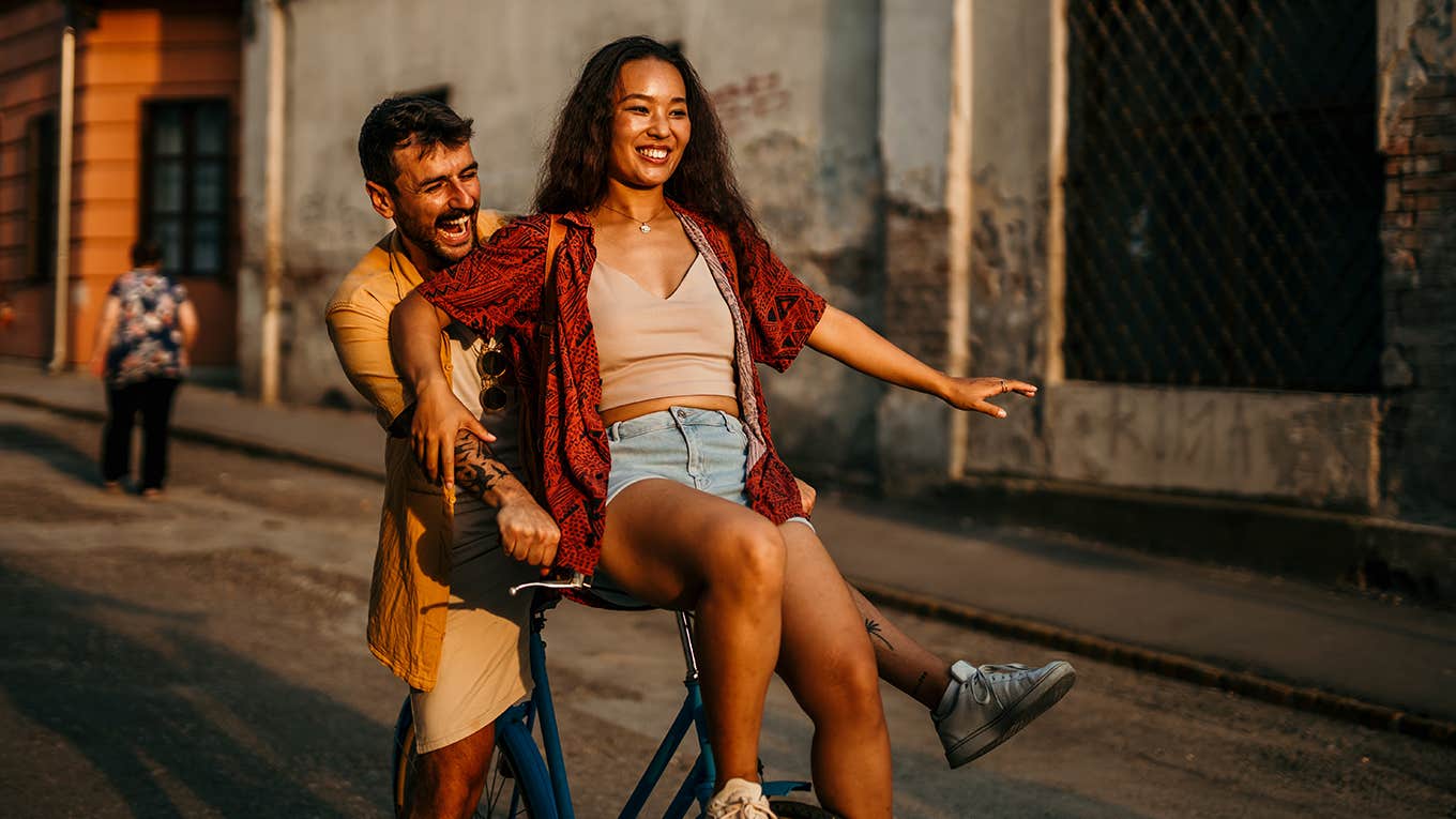 couple having fun riding bike together