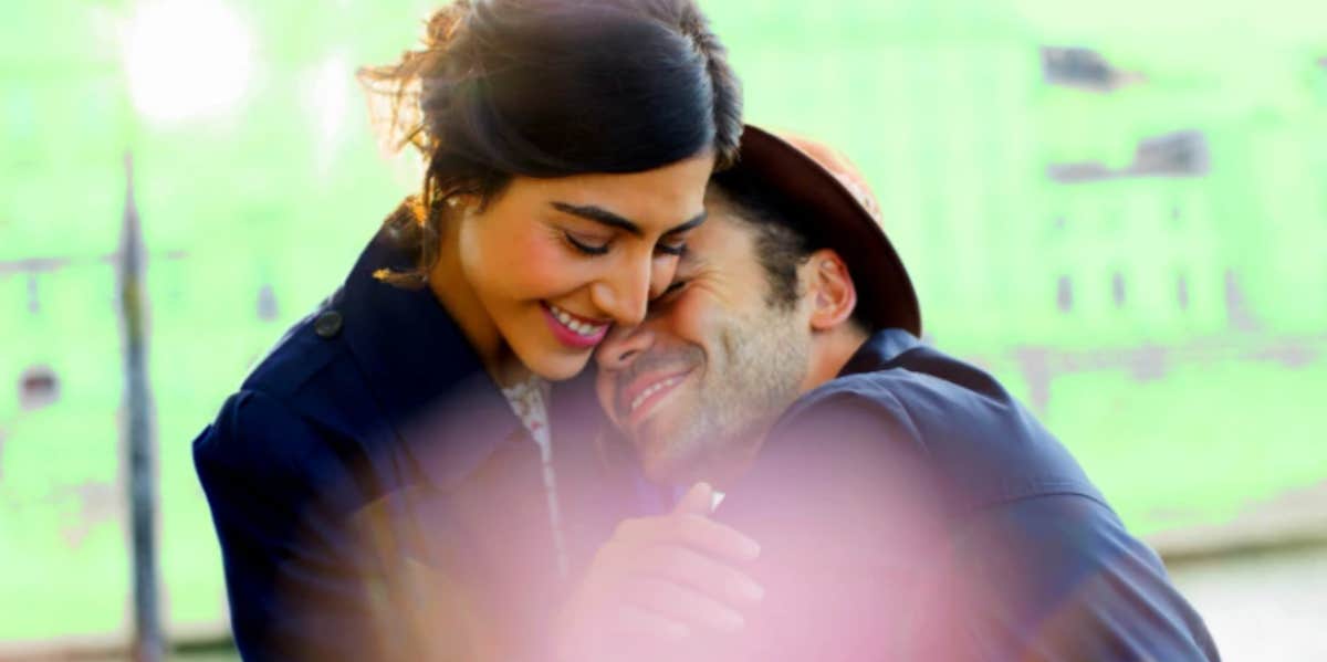 7 Subtle Ways Shy People Flirt And How To Flirt Back woman and man embracing and smiling