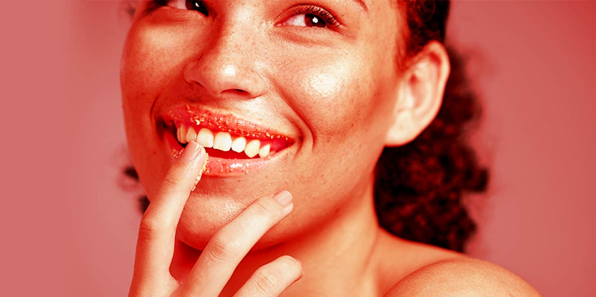 woman exfoliating her lips