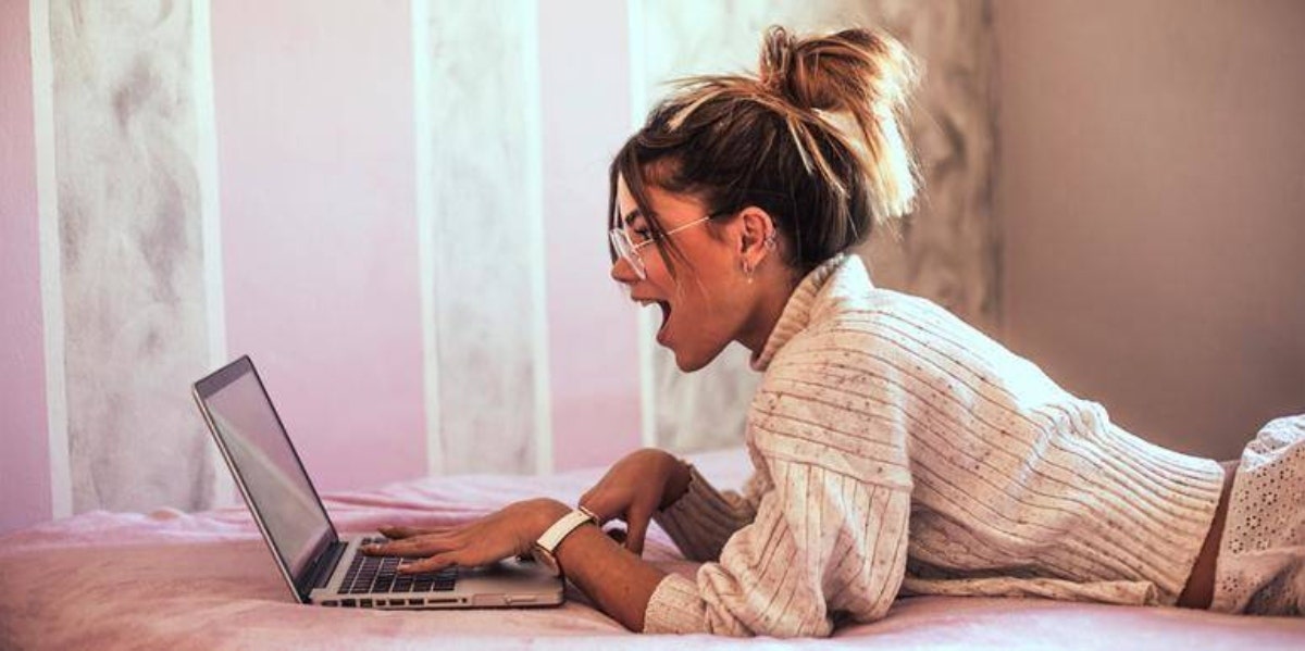 shocked woman looking at laptop