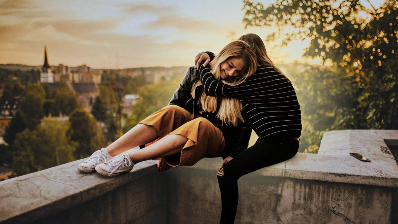 two friends talking and hugging