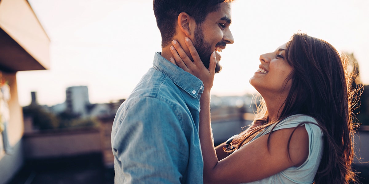 man and woman embracing and laughing together