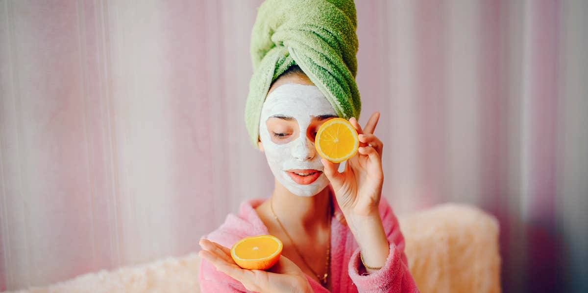 How To Give Yourself A Facial In 10 Steps woman having an at home facial