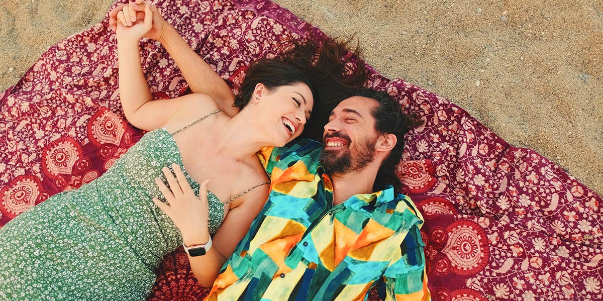 couple laying together on beach