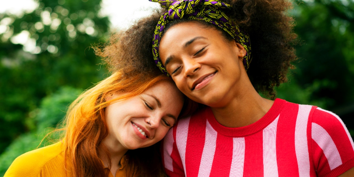 Two women smiling and hugging