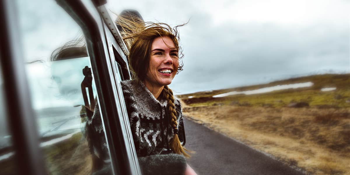 The alternate PTSD treatment that healed me woman, smiling, hanging out of a car window in the high desert