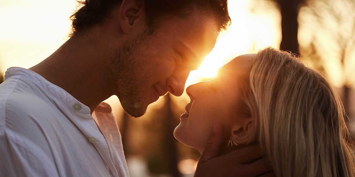 man pulling woman in for a kiss