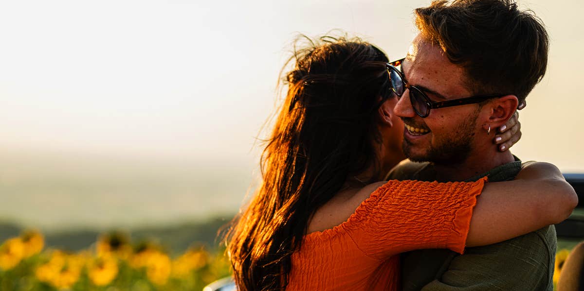 couple hugging in sunflower field