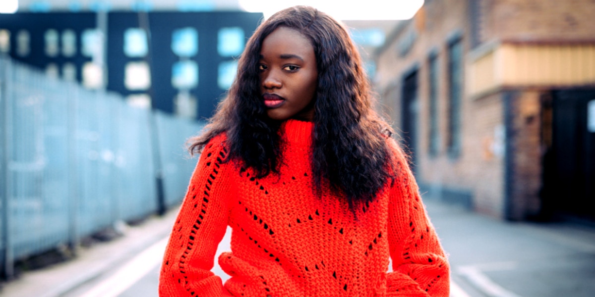 serious woman in red sweater