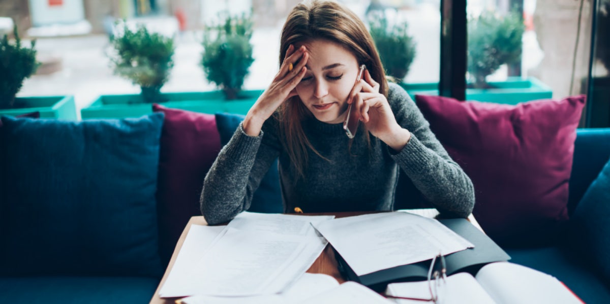 woman stressed with work papers