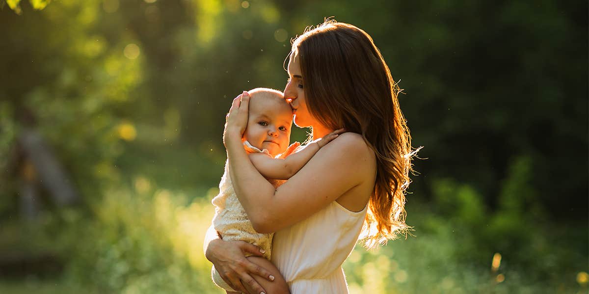 mom kissing baby