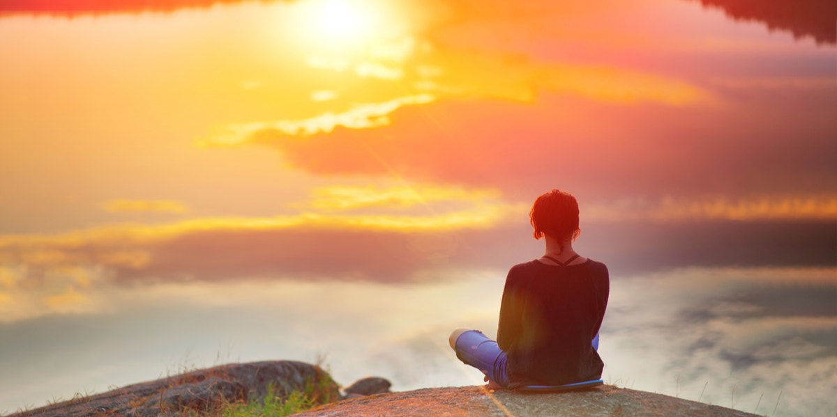 woman meditating on mountain