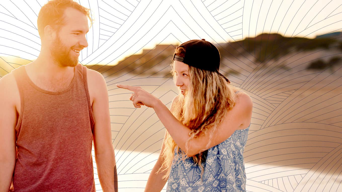 happy couple walking down the beach being silly