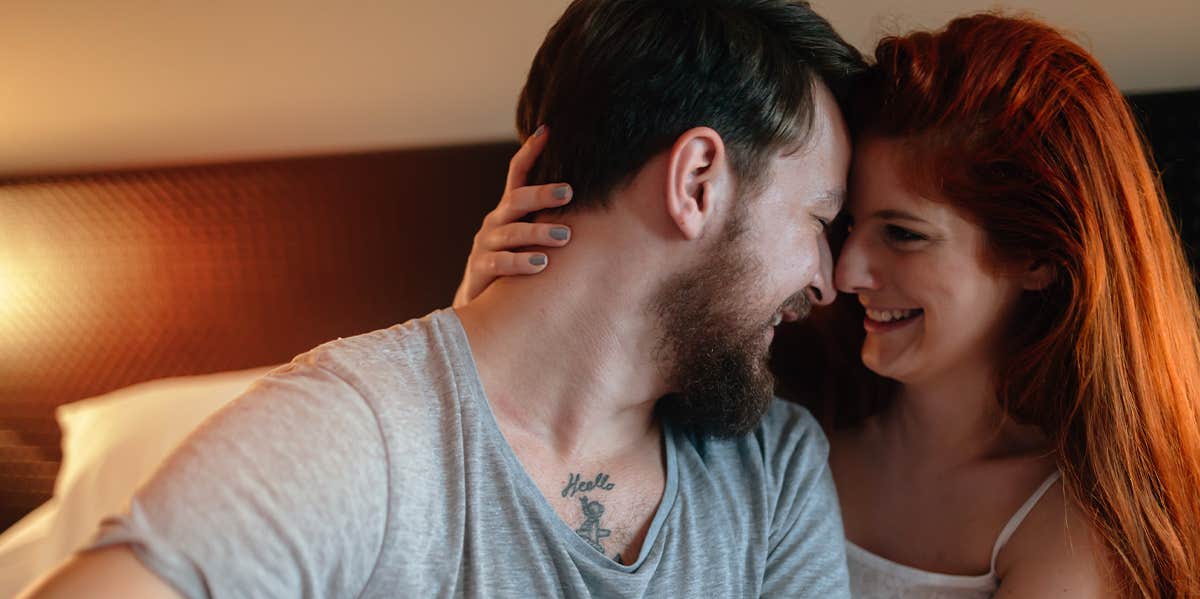 woman pulling man close for a kiss