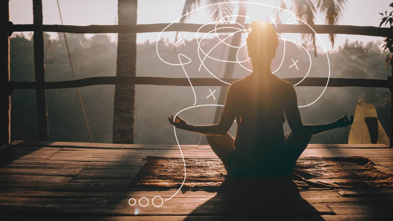 Woman meditating on balcony