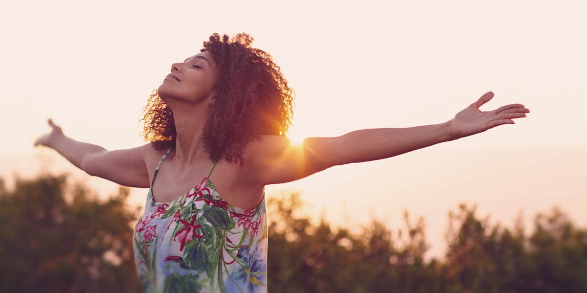 woman holding her arms up