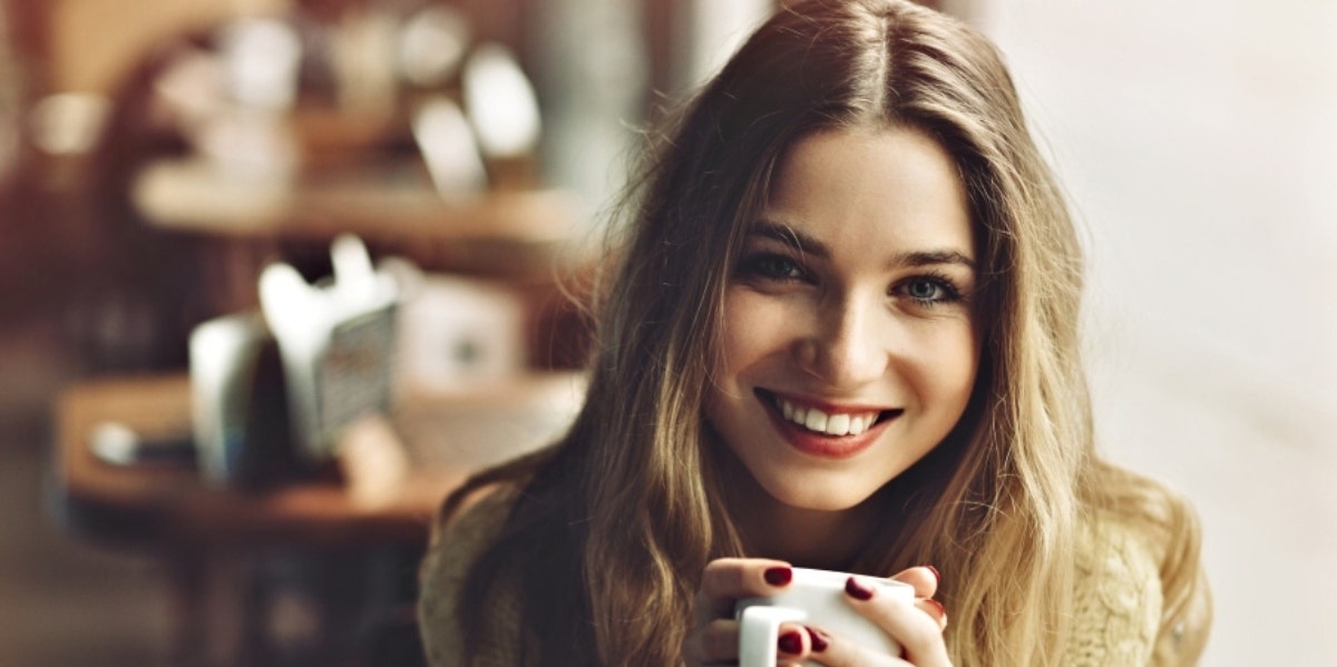 smiling woman experiencing past life regression