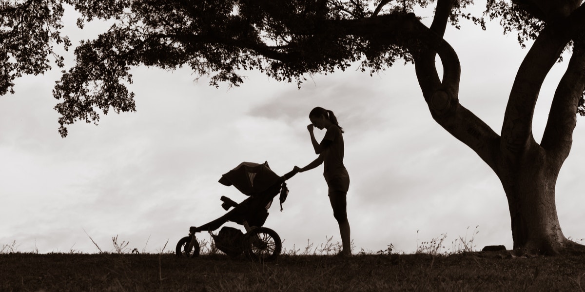 sad mother with baby in stroller