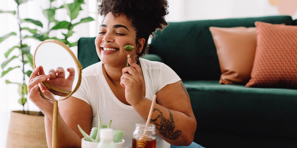 woman ice rolling her face doing self care at home