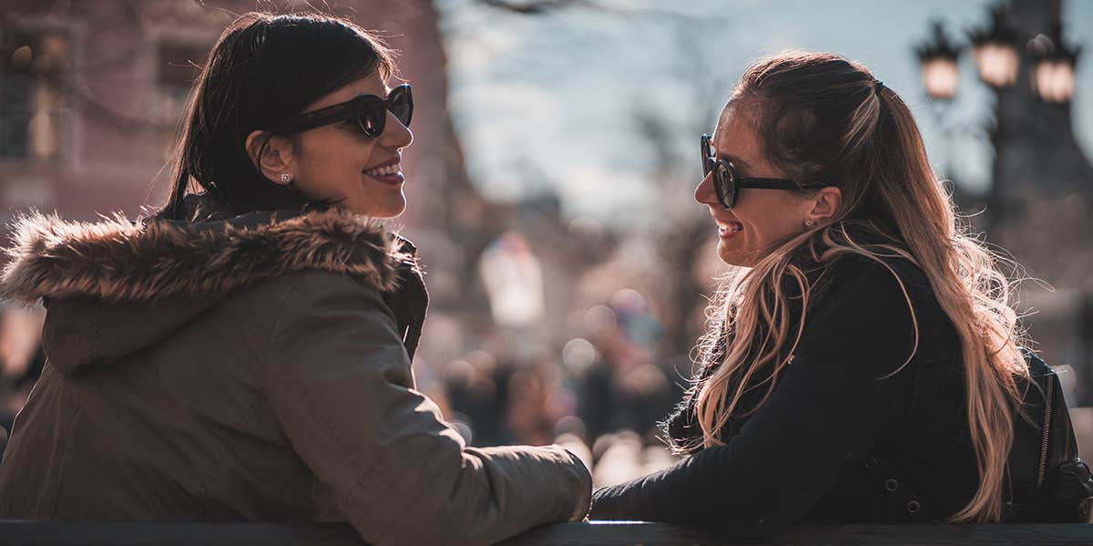 two women talking on bench