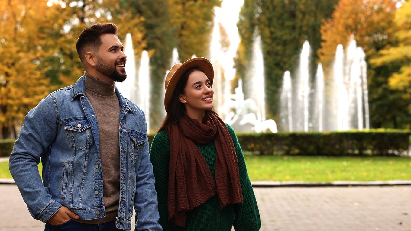 couple walking in park holding hands