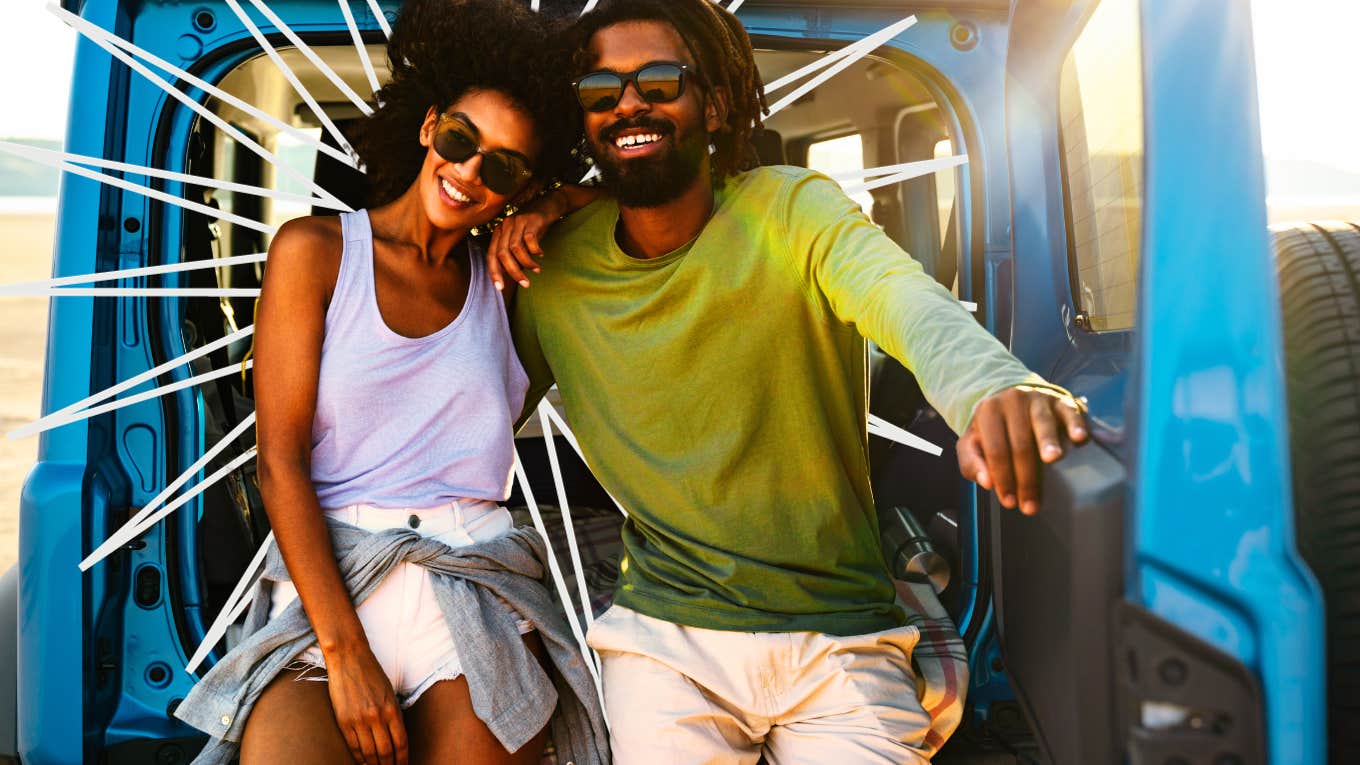 Couple sitting in the back of a jeep