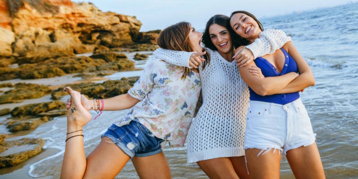 friends laughing smiling on the beach