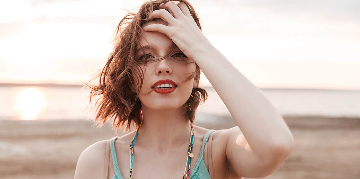 woman staring at camera with hand in hair