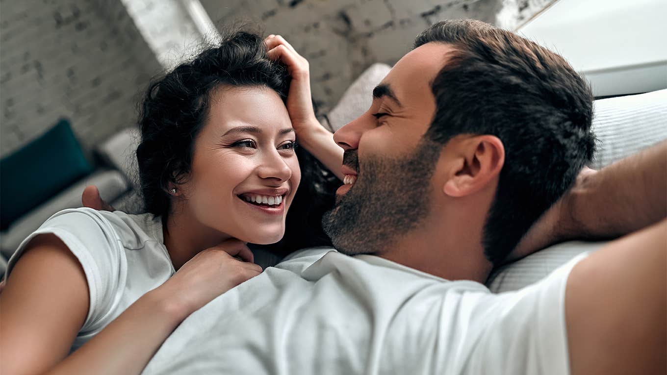 couple laughing together in bed