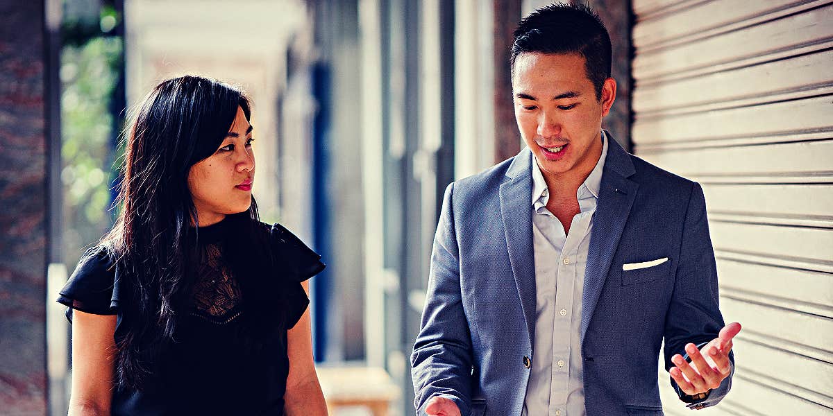 male and female colleagues walking and talking 