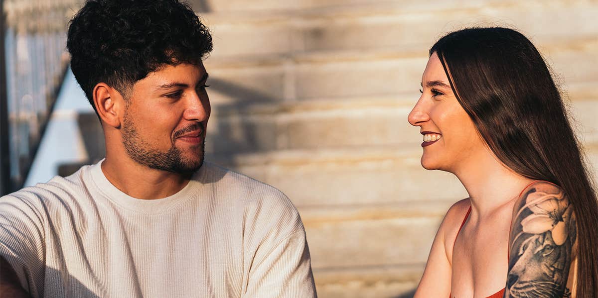 guy and girl sitting on steps chatting