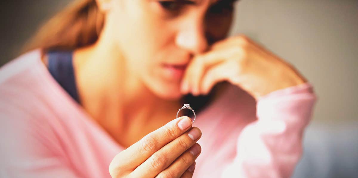 woman looking at a diamond ring